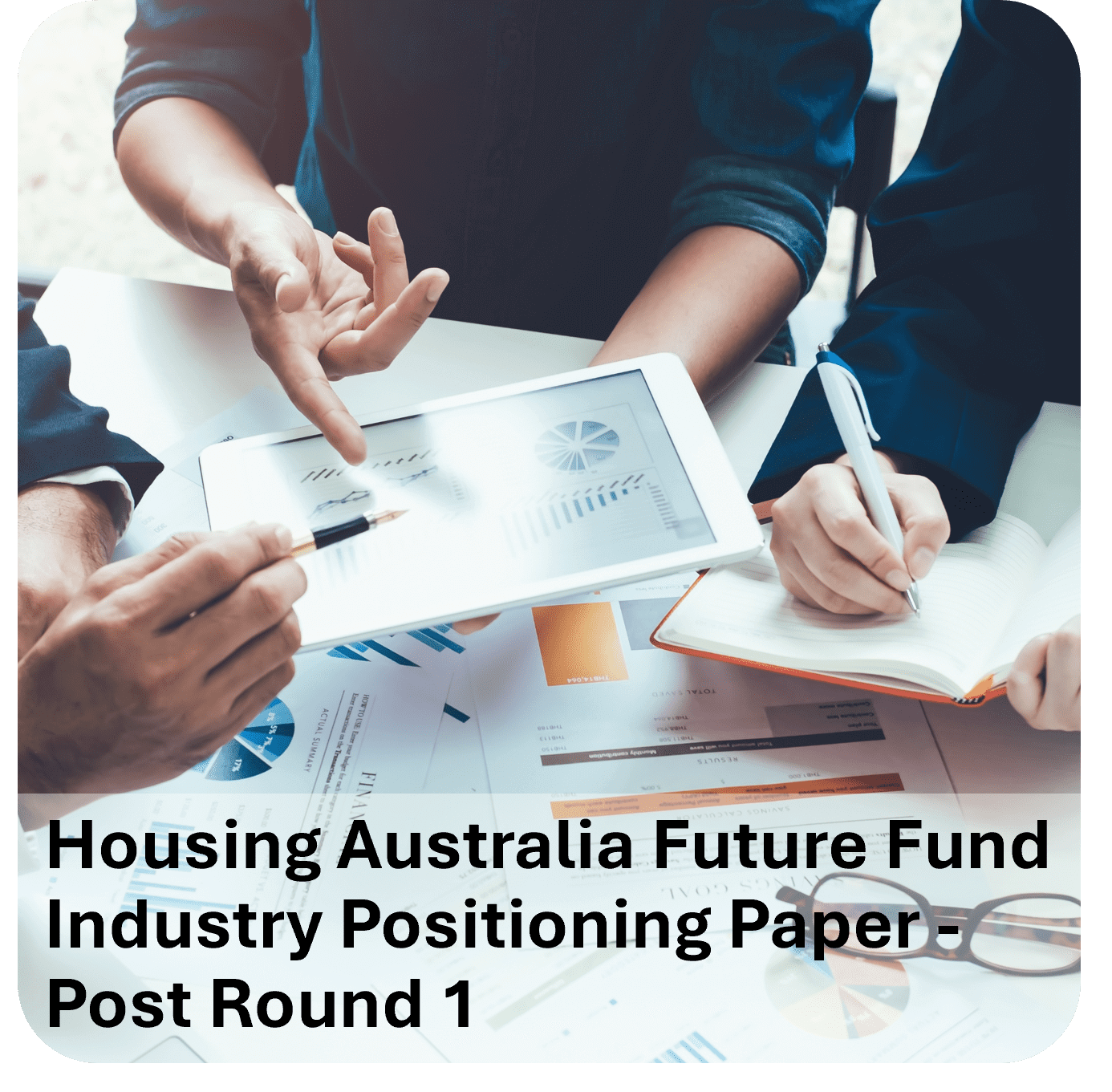 Two professionals discussing graphs and housing data in a meeting.