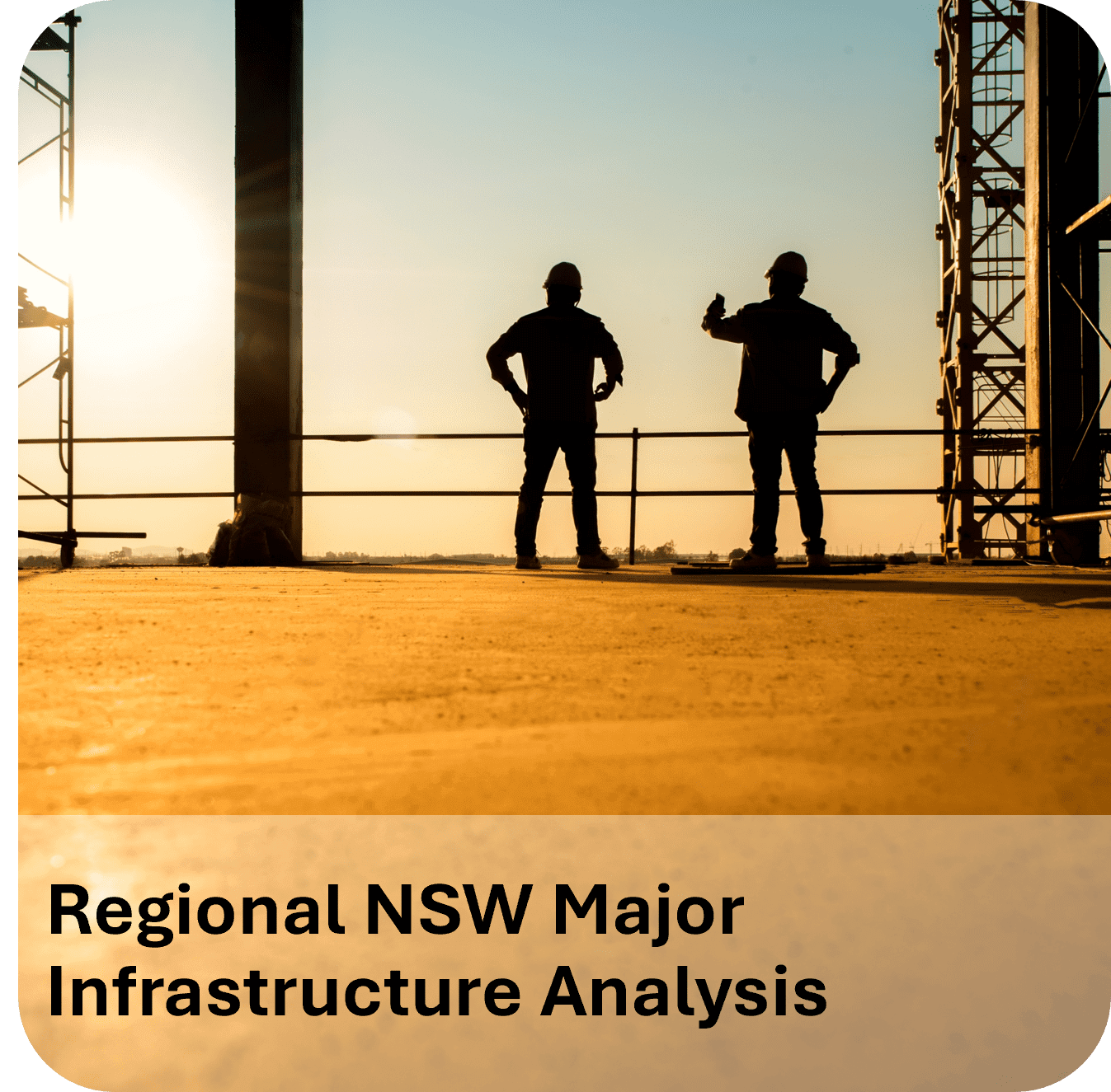 Two workers stand inside a construction site overlooking a bright horizon.