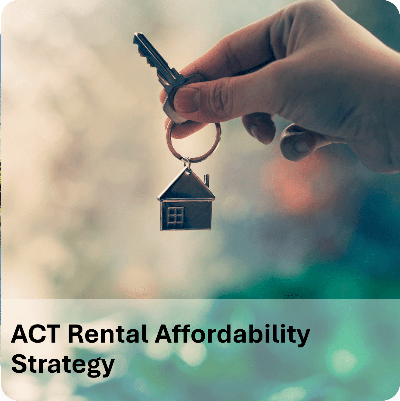 Hand holding house-shaped keychain