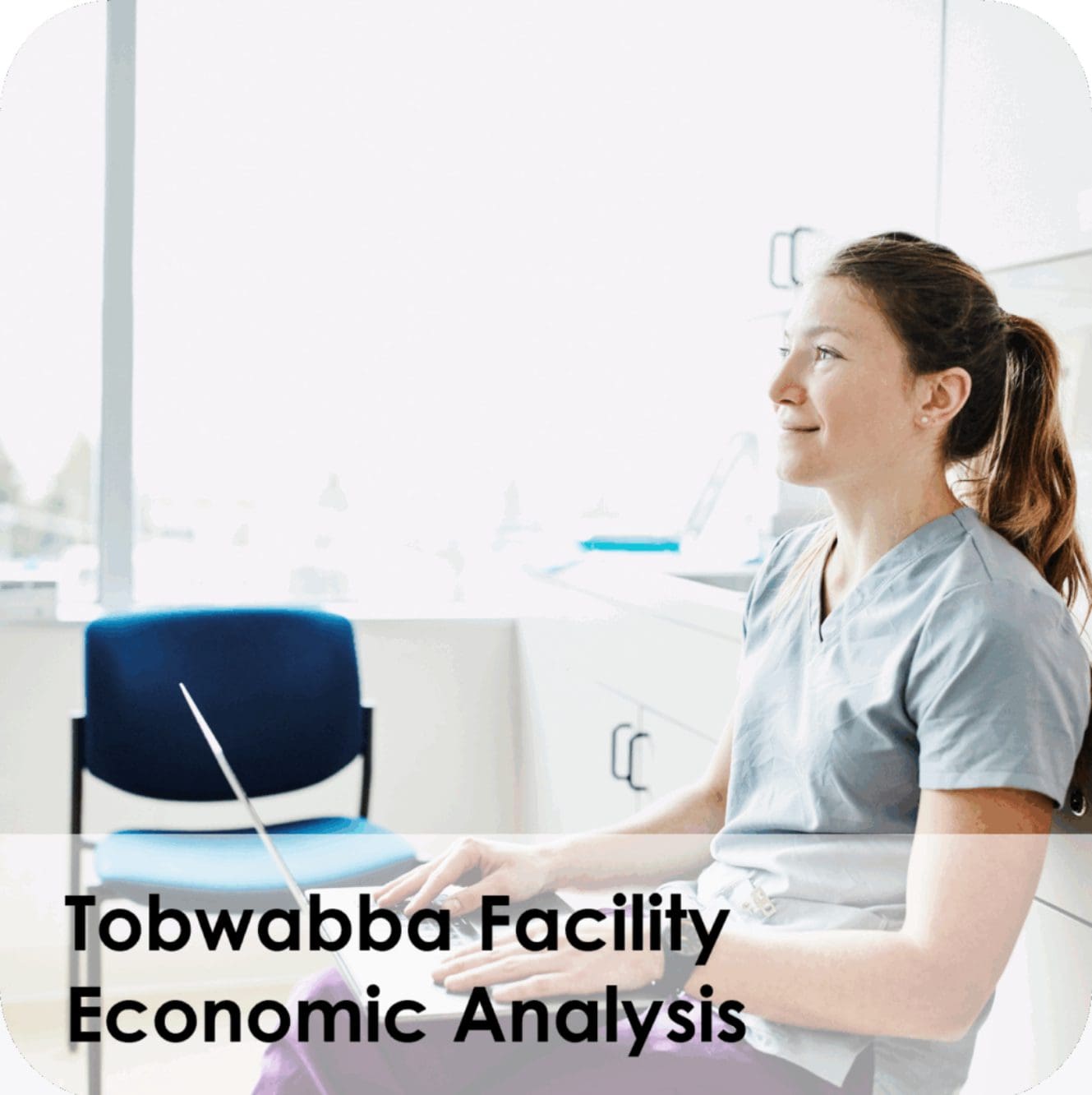 Healthcare professional using laptop in bright clinic